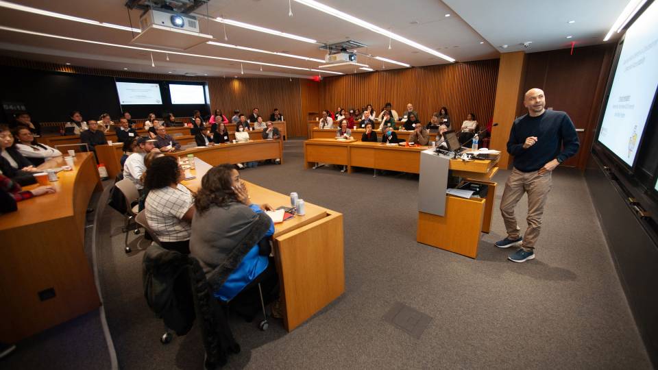 Professor White giving a talk at a lectern
