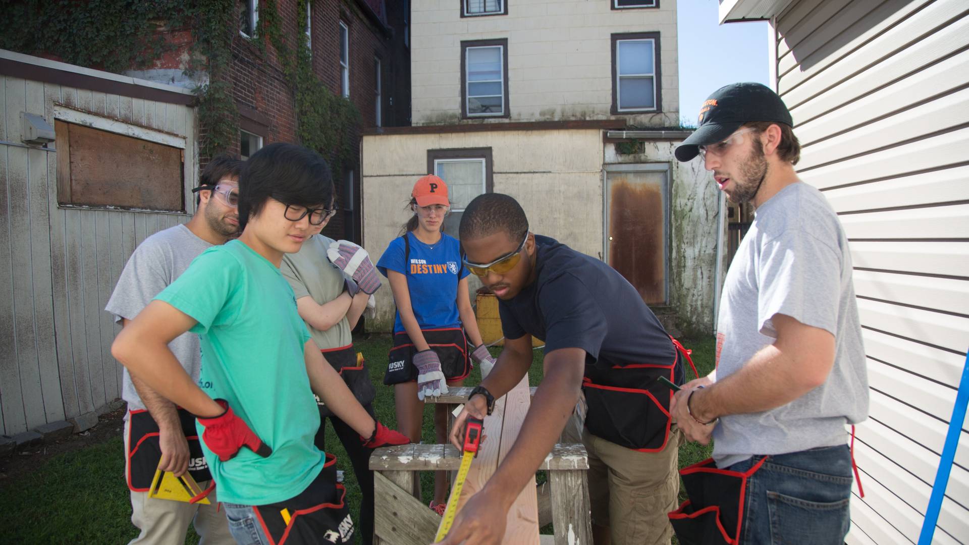 Students measuring wood for trimming