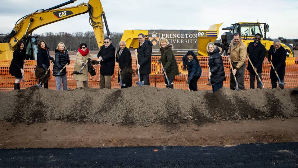 People with shovels dig into a mound of earth in West Windor