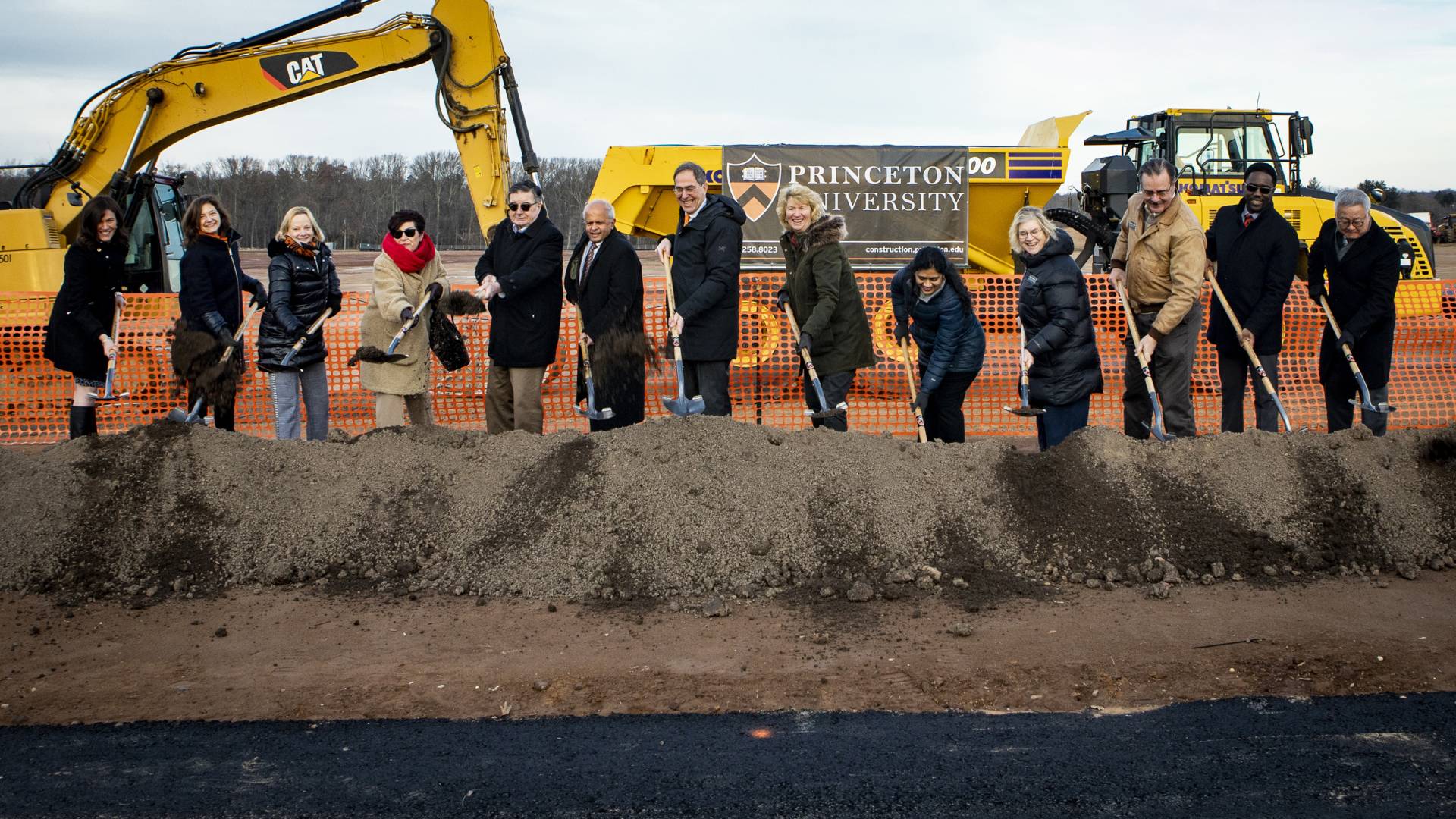 People with shovels dig into a mound of earth in West Windor