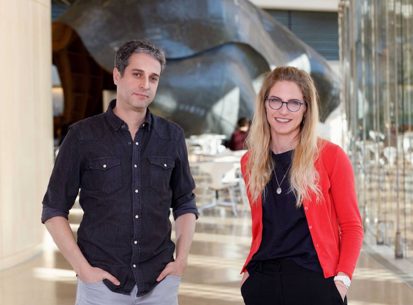 Two researchers in the atrium of the Icahn building