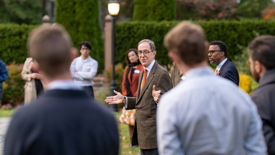 Pres. Eisgruber outdoors speaking to a group of people