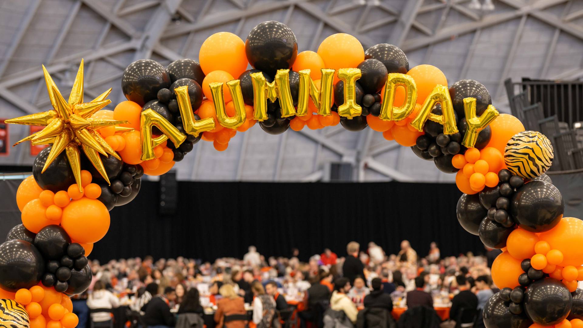 Balloon letters: "Alumni Day"