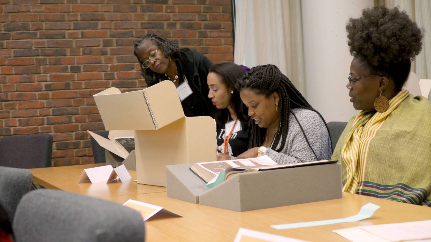 Students and faculty looking at archival materials